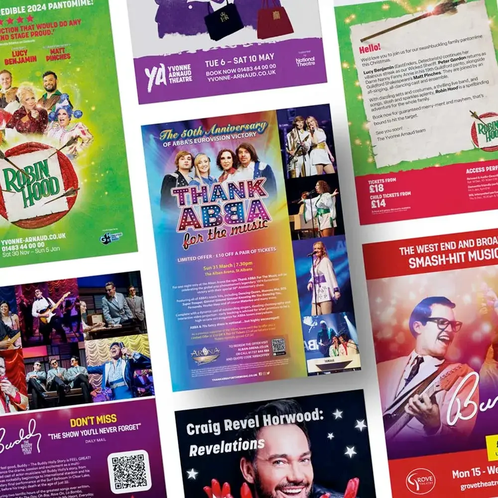 Collection of colorful theatrical posters and brochures featuring pantomimes and musicals including Robin Hood, ABBA tribute.
