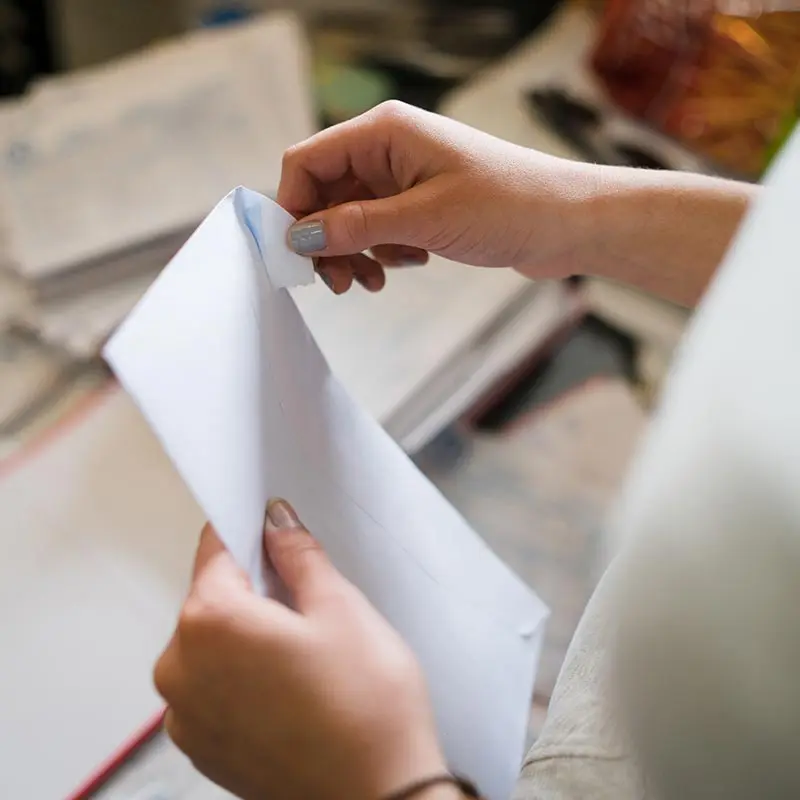 Woman opening envelope post Sharp Cat